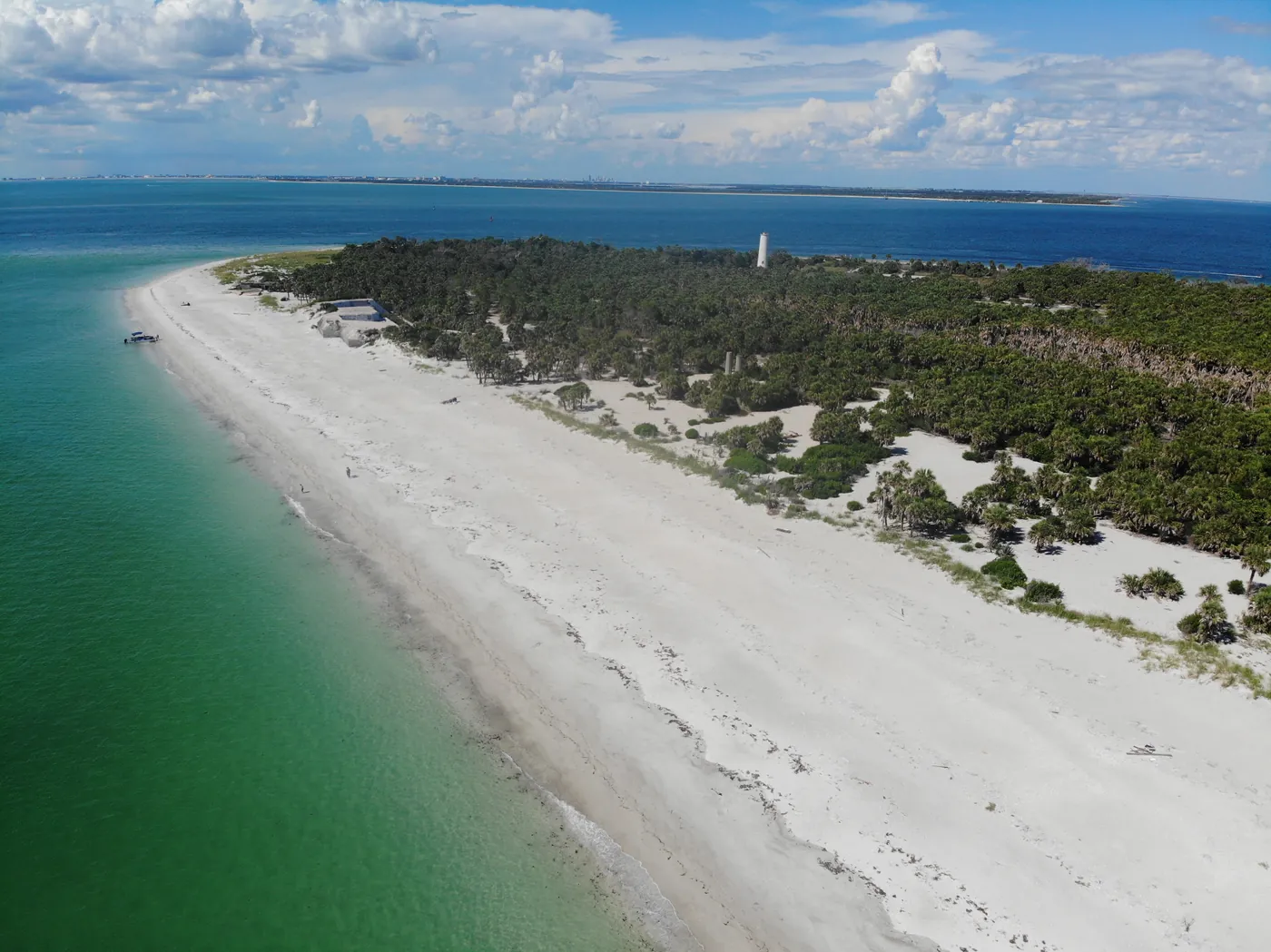 Aerial view along the white sand beach of Egmont Key with the lighthouse in the distance