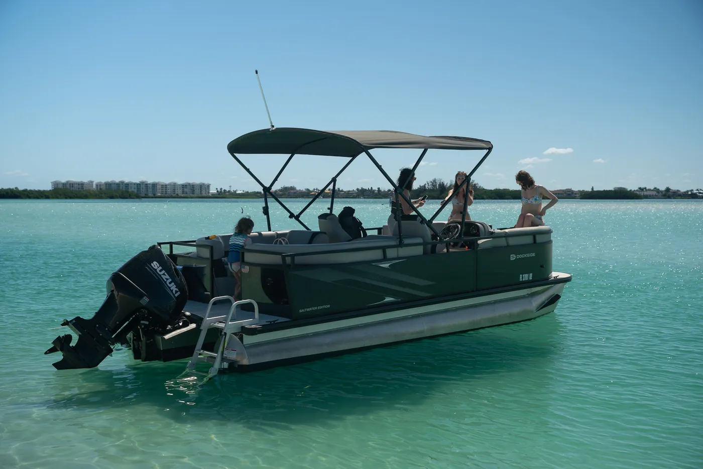 Guests seated aboard the pontoon while anchored in shallow water off Pinellas County