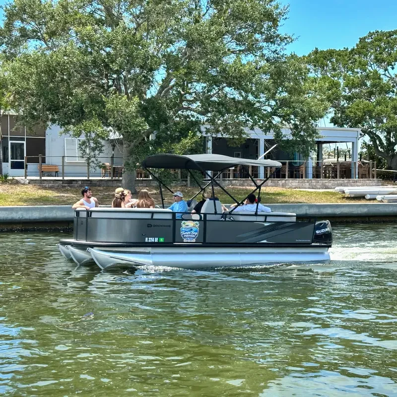 Guests relaxing on the bow of a Tampa Bay Pontoon Rentals pontoon boat on Boca Ciega Bay